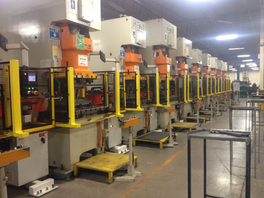 9 small presses in a row with Linear tandem line press transfer systems connecting them.